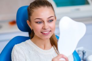 woman looking in dental mirror